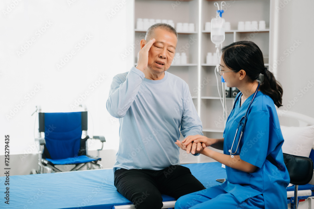 Obraz premium Asian female hands touching senior male hand Helping hands take care of the elderly concept