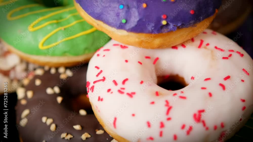 Different donuts rotate in a circle on a black background Different donuts rotate in a circle on a black background