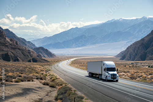 Semi truck driving on desert highway with mountain backdrop. Transportation and logistics.