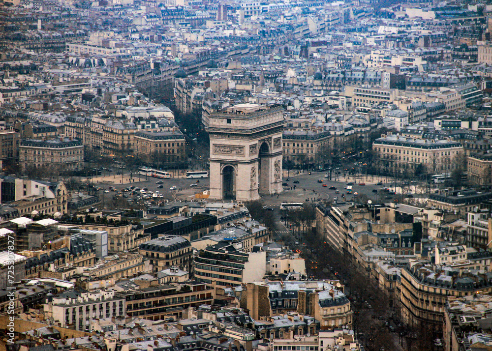 An aerial view of Arc de Triomphe and the city of Paris from the top of the Eiffel Tower