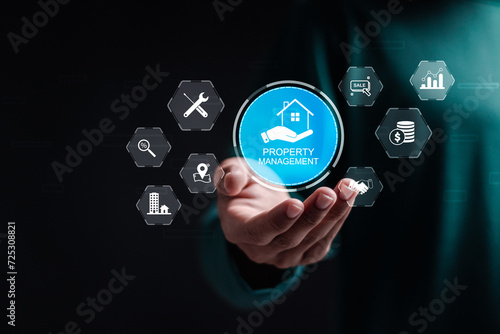 Property management concept. Businessman holding virtual screen of property management icon for operation control maintenance and oversight of real estate and physical property. photo