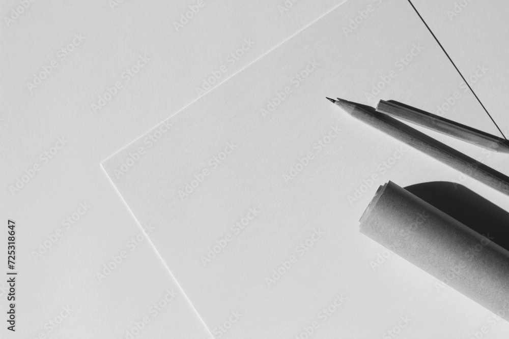 Design Studio Mockup. Minimal Black and White Flatlay with Blank Paper Sheets, Graphite Pencils, Paper Roll on White. Design Studio Mockup. Minimal Black and White Flatlay with Blank Paper Sheets, Graphite Pencils, Paper Roll on White.