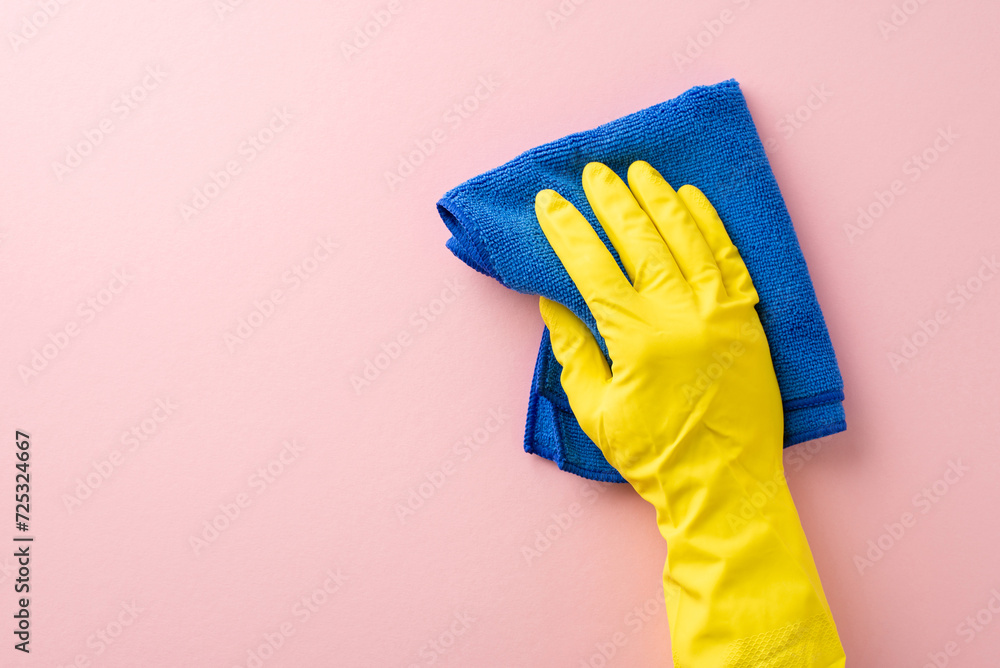 A first-person perspective photo featuring a hand in a rubber glove, using a soft cleaning cloth on a gentle pink background, perfect for housecleaning ads with space for text A first-person perspective photo featuring a hand in a rubber glove, using a soft cleaning cloth on a gentle pink background, perfect for housecleaning ads with space for text