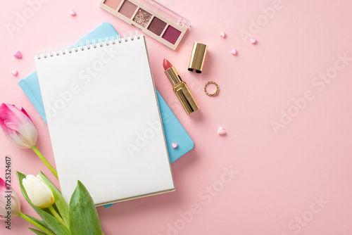 Elegance Unleashed: Top view shot of fresh tulips, stylish notebooks, eyeshadow palette, lipstick, ring, and hearts on pastel pink. Embrace the perfect lady concept with space for text or ads