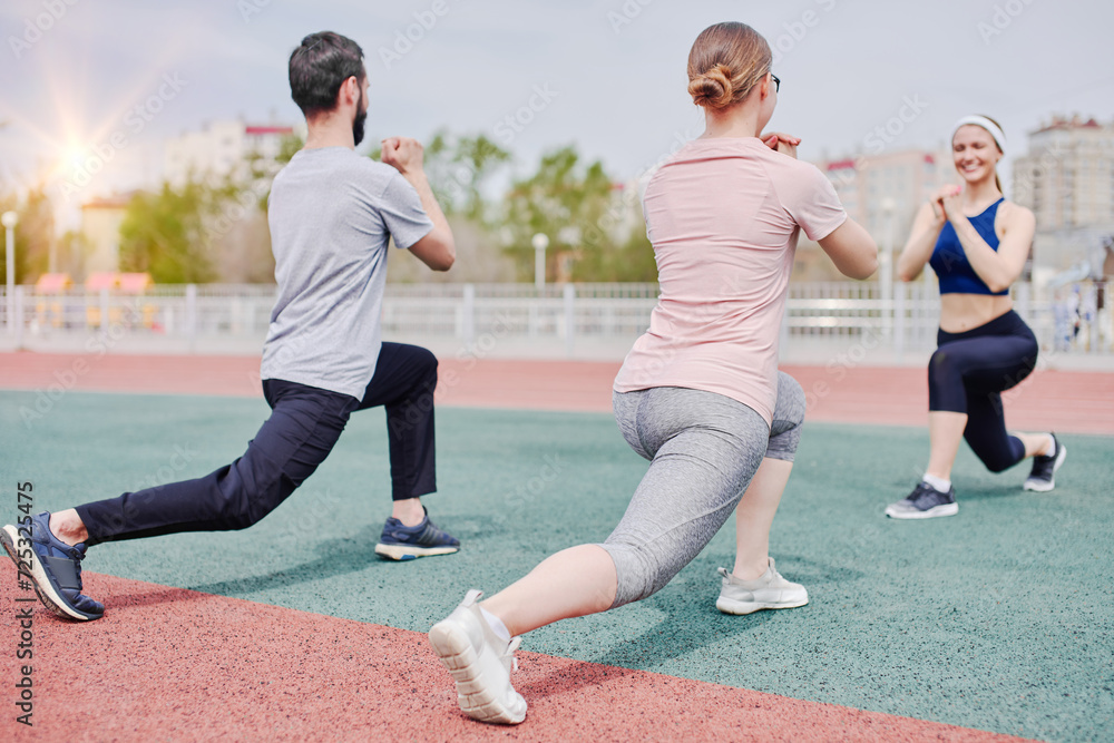 Warming up exercises for legs with a trainer outdoors