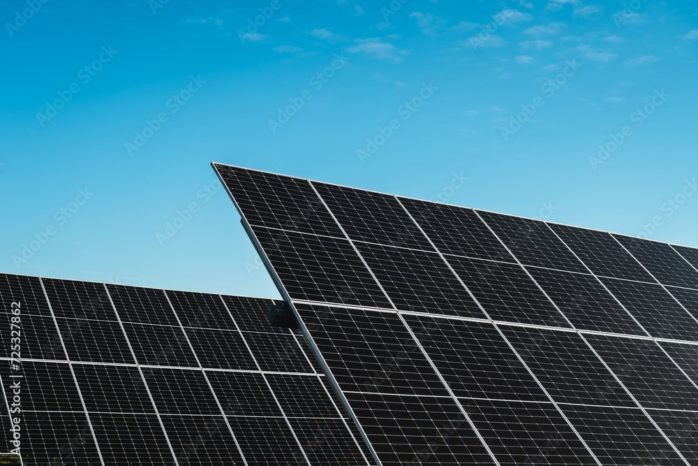 solar panel array in photovoltaic solar park under blue sky, bright sunny day solar panel array in photovoltaic solar park under blue sky, bright sunny day