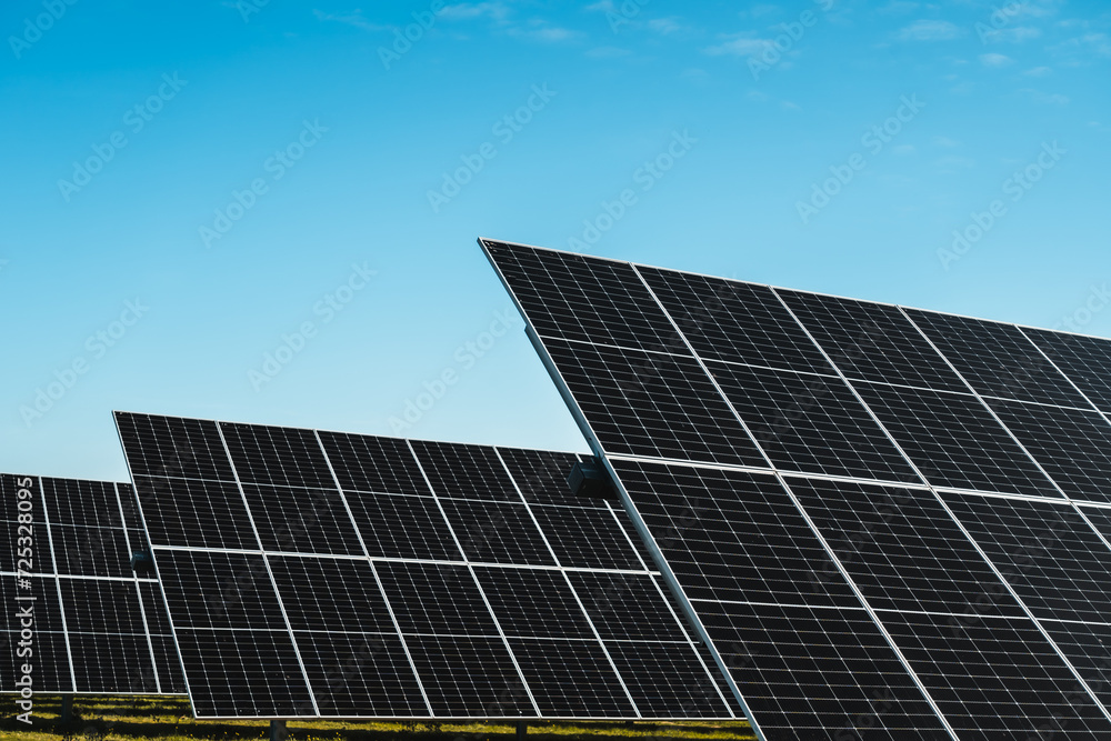 detail of solar panels in photovoltaic solar park under blue sky, bright sunny day detail of solar panels in photovoltaic solar park under blue sky, bright sunny day