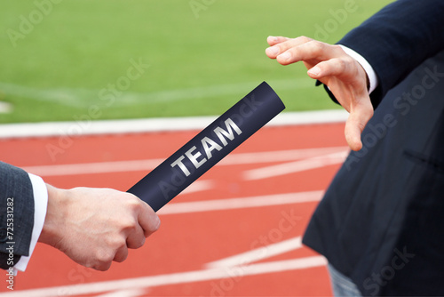 Passing team baton in relay race business men hand over 