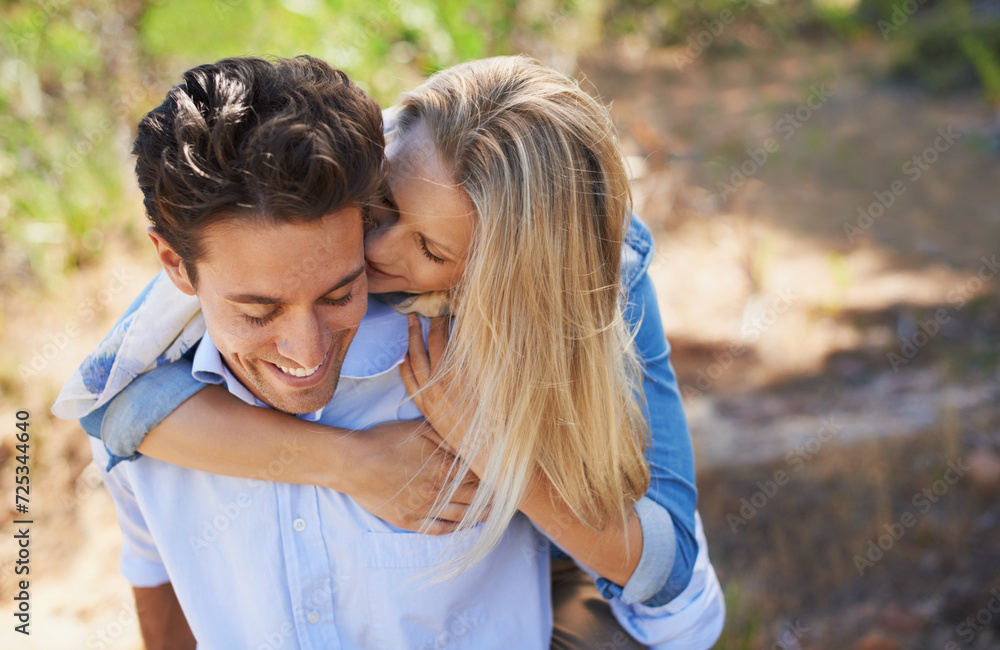 Happy couple, kiss and cheek in piggyback for love, bonding or support for outdoor affection in nature. Face of young woman and man smile for embrace, hug or romantic back ride in forest together Happy couple, kiss and cheek in piggyback for love, bonding or support for outdoor affection in nature. Face of young woman and man smile for embrace, hug or romantic back ride in forest together