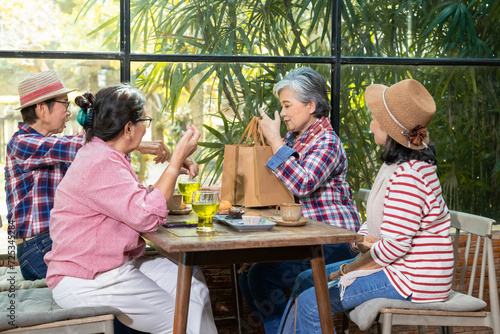 Social aging lifestyle wellness elderly female happy on holiday vacation trip, elderly businesswoman buying gift boxes to celebrate pensioner friends relationship in retirement enjoy tea time at cafe