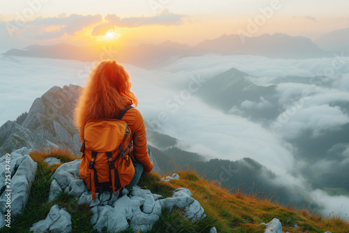 Girl on mountain peak looking at beautiful mountain valley in fog at sunset. Travel and tourism hiking. photo