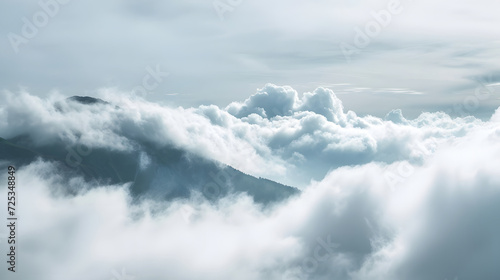 Misty Mountain Peaks Surrounded by Fluffy White Clouds
