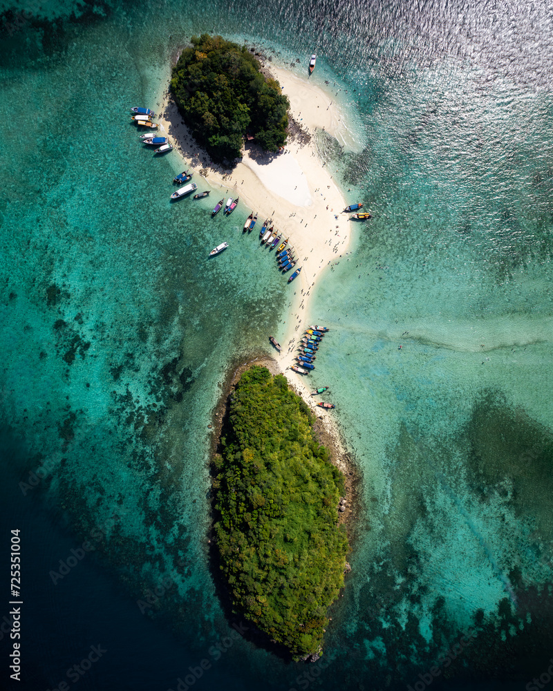 A breathtaking aerial view captures the pristine beauty of Krabi's enchanting island, adorned with turquoise waters and lush greenery