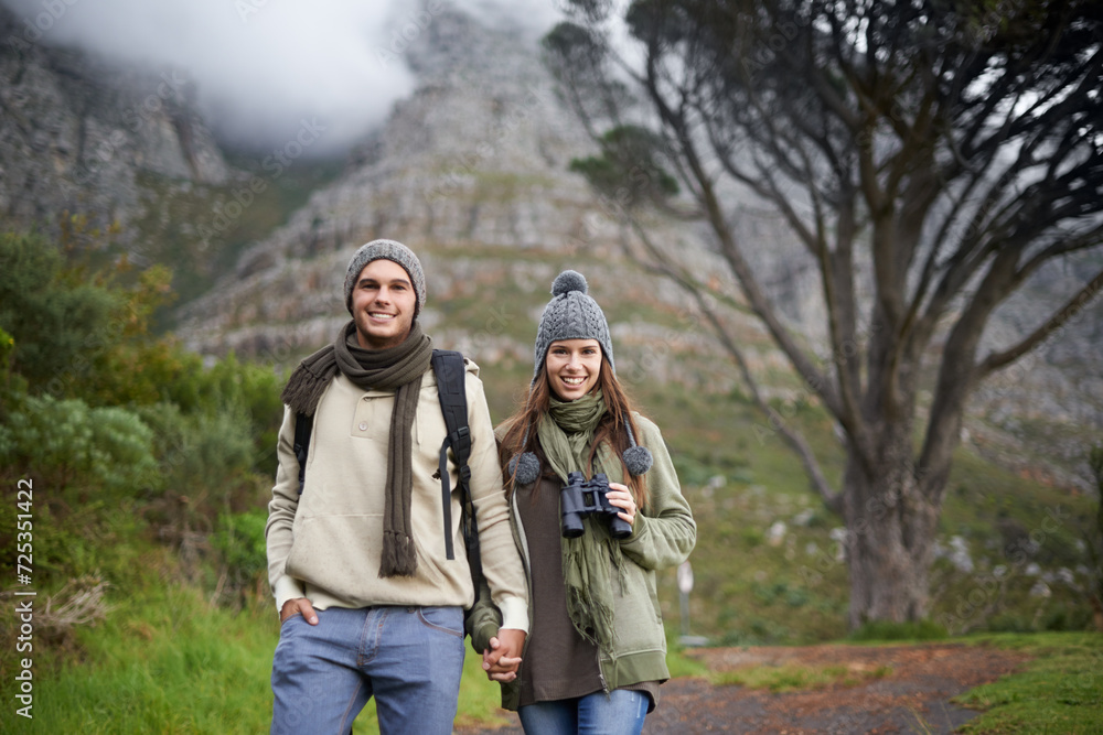 Couple, portrait and hiking on mountain or holding hands with travel, adventure or holiday for experience or love. Man, woman and trekking outdoor on trail for cardio, exercise or happy and binocular