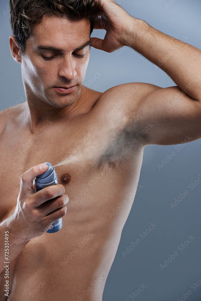 Man, deodorant and spray for armpit odor in studio or product application for clean smell, hygiene or grey background. Male person, topless and confidence or health wellness, care or mockup space Man, deodorant and spray for armpit odor in studio or product application for clean smell, hygiene or grey background. Male person, topless and confidence or health wellness, care or mockup space
