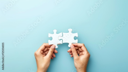 Concept of business,hands holding a jigsaw puzzle on pastel blue background