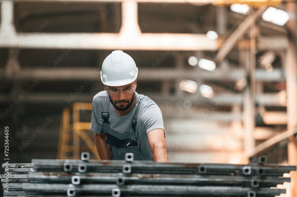 Young factory worker in grey uniform Young factory worker in grey uniform