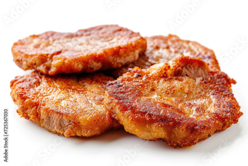 Succulent fried pork medallions  perfectly seared and isolated on a white background