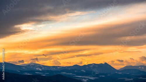 orange sky in the morning over a cloud layer and mountain © Ewald Fröch