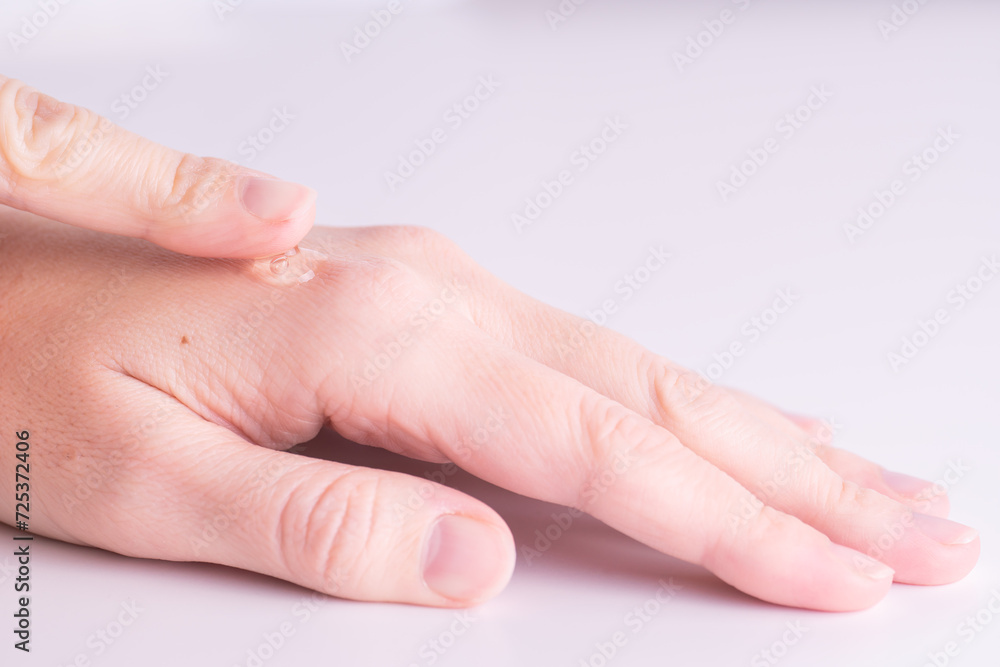 Woman applying gel or serum on hands, close-up. Hand Care Woman applying gel or serum on hands, close-up. Hand Care