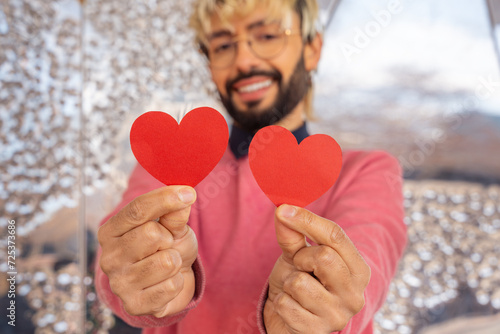 Shot smiling young woman holding hearts. lovers photo