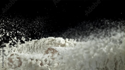 The rolling pin falls into the flour. Filmed on a high-speed camera at 1000 fps. High quality FullHD footage photo