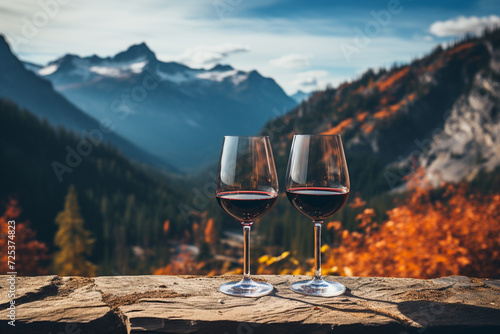 Two glasses of red wine in the mountains. Romantic evening. Eco style