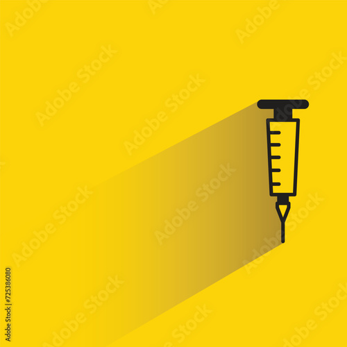 medical syringe icon with shadow on yellow background