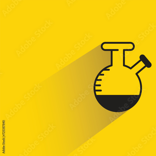 science flask with shadow on yellow background