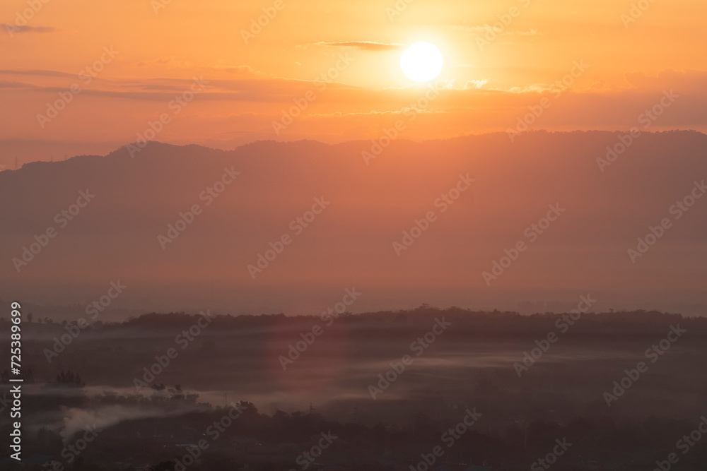 Beautiful morning scenery with Misty Mountain Morning Landscape with Fog and a Beautiful Sunrise Overlooking Hills, Valleys, and a Tranquil Lake, environmental themes