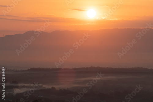Beautiful morning scenery with Misty Mountain Morning Landscape with Fog and a Beautiful Sunrise Overlooking Hills, Valleys, and a Tranquil Lake, environmental themes