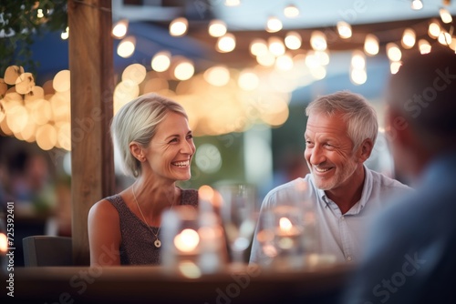 smiling couple dining, soft focus fairy lights, balmy evening air photo