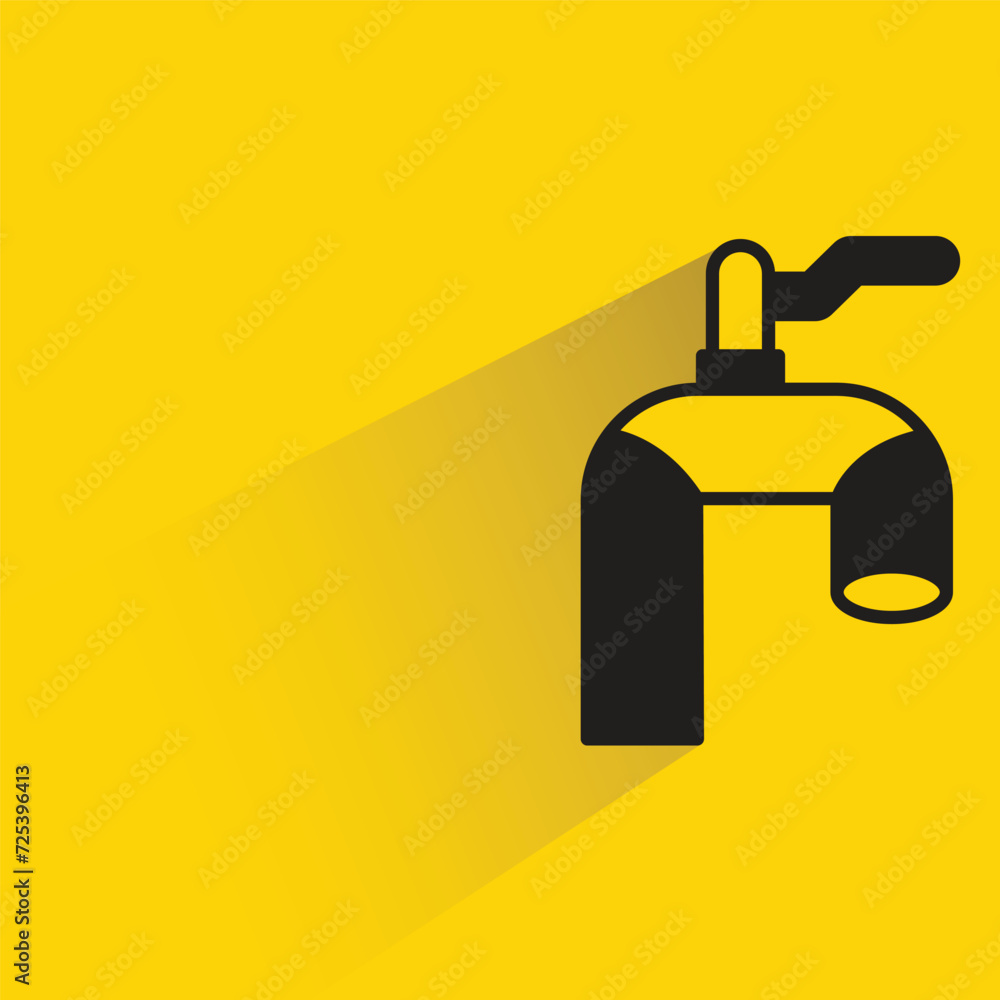 water tap with shadow on yellow background water tap with shadow on yellow background