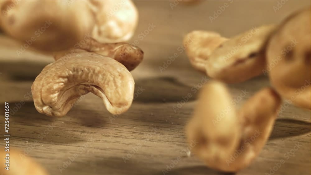 Cashew nuts fall on the table. Filmed on a high-speed camera at 1000 fps. High quality FullHD footage Cashew nuts fall on the table. Filmed on a high-speed camera at 1000 fps. High quality FullHD footage