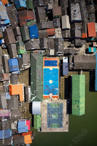 Mesmerizing aerial shot of Koh Panyee, Thailand's floating village. Vibrant stilted structures rise above the turquoise waters, capturing the essence of a unique and captivating way of life