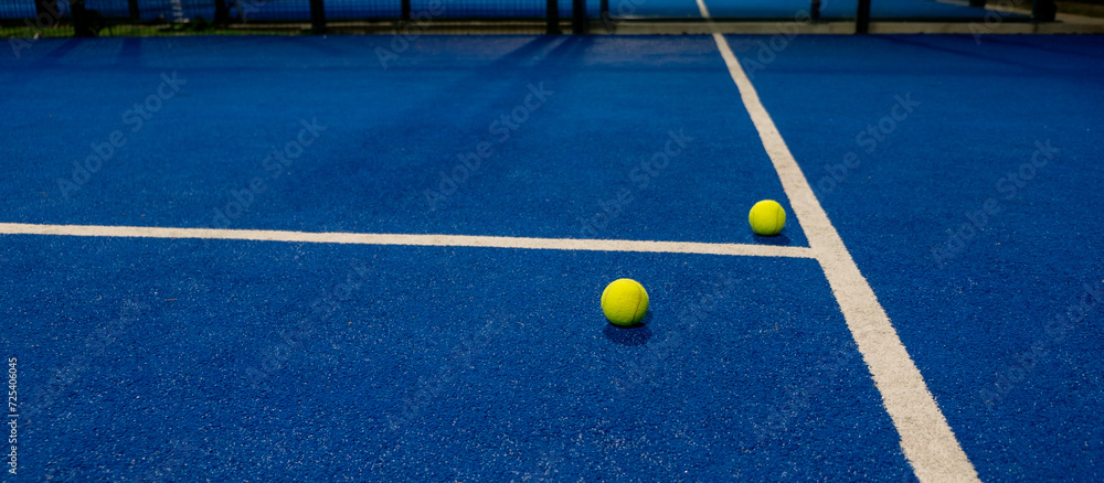 selective focus, two balls on a paddle tennis court in the night, racket sports concept
