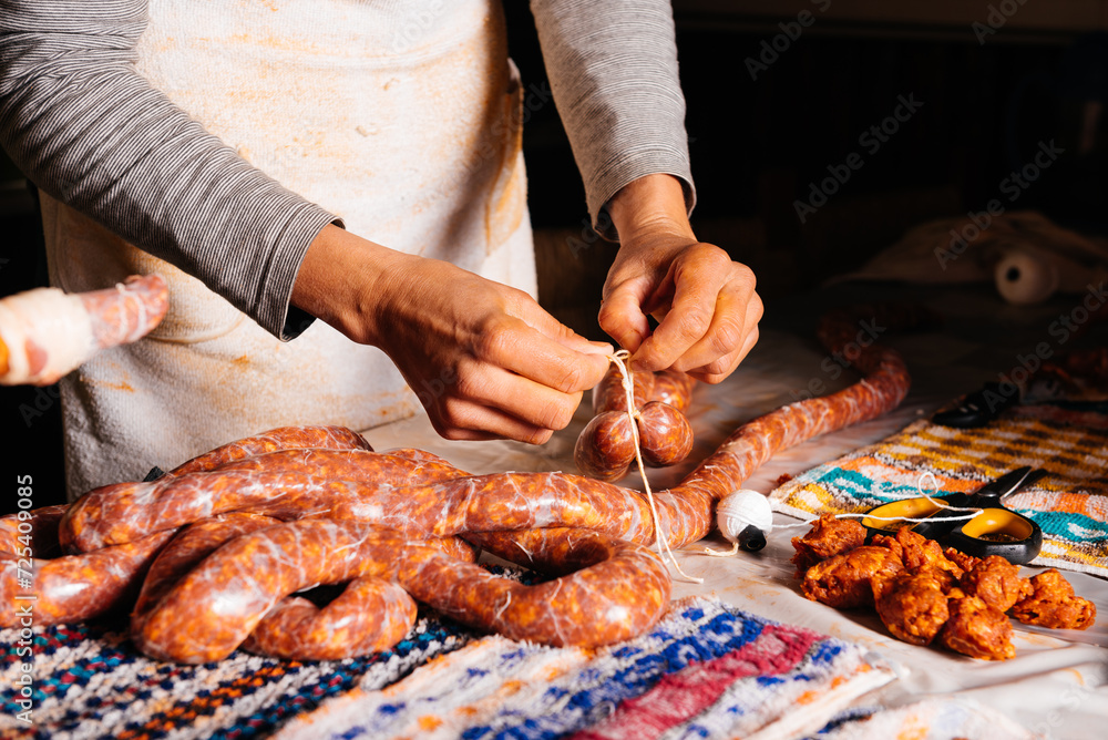 Crop female butcher making homede sausages