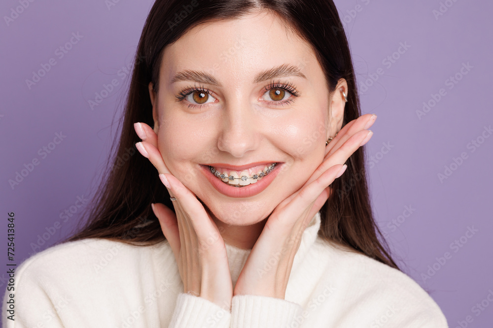 portrait of a girl with braces, woman happy with braces shows ok sign portrait of a girl with braces, woman happy with braces shows ok sign