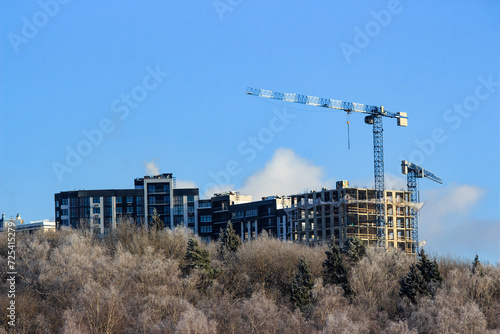 New buildings rising above the treetops, city growth © PhotoChur