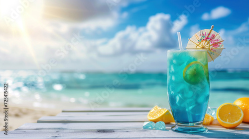 Blue hawaii cocktail on white wooden table with blue sea and sky background.