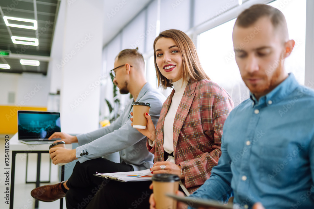 Fototapeta premium Office work. Young entrepreneurs collaborating on a new project in a Modern Bright Office. Planning, business, study, collaborate work in teamwork.