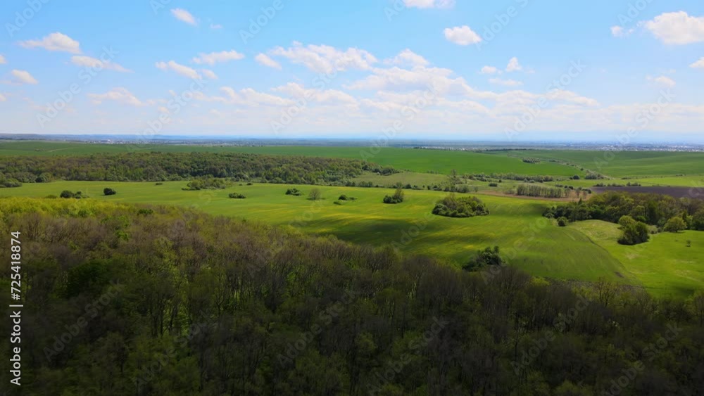 Aerial view of green farm fields in summer season with growing crops. Farming and agriculture industry Aerial view of green farm fields in summer season with growing crops. Farming and agriculture industry