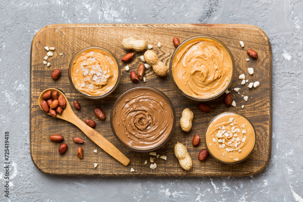 Glass jar with peanut butterin plate on table background, top view space for text and close up Glass jar with peanut butterin plate on table background, top view space for text and close up