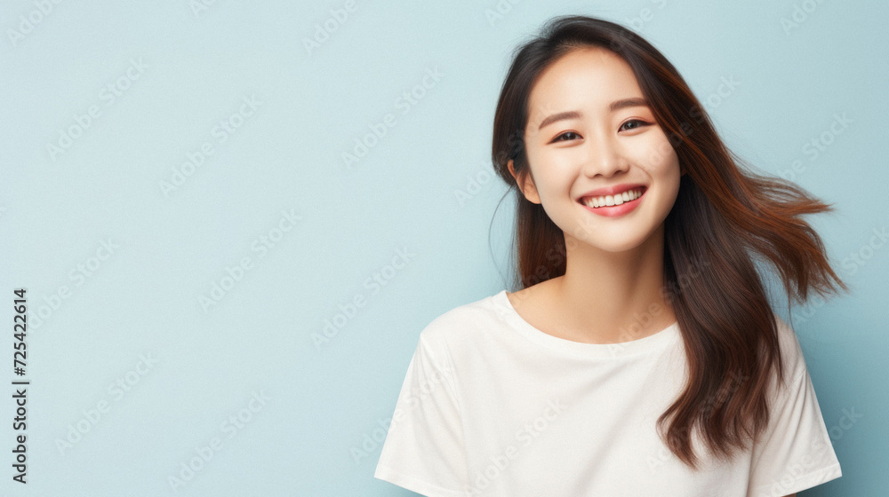 Young happy smiling Asian woman model wearing tshirt looking at camera on color background. Face skin hair care korean cosmetic and makeup, fashion ads. Beauty portrait. White t-shirt mock up template Young happy smiling Asian woman model wearing tshirt looking at camera on color background. Face skin hair care korean cosmetic and makeup, fashion ads. Beauty portrait. White t-shirt mock up template