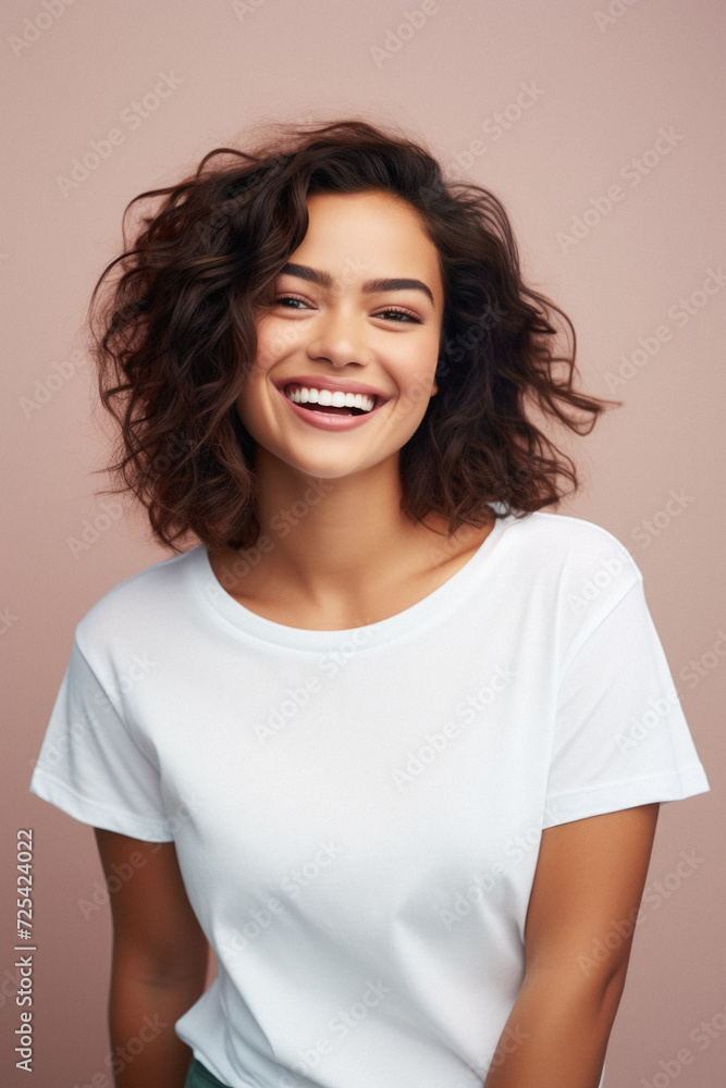 Young happy smiling Latin woman model wearing tshirt standing on color background. Face skin treatment, curly hair care cosmetics makeup, fashion ads. Beauty portrait. White t-shirt mock up template . Young happy smiling Latin woman model wearing tshirt standing on color background. Face skin treatment, curly hair care cosmetics makeup, fashion ads. Beauty portrait. White t-shirt mock up template .