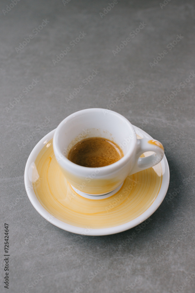 Close up of a cup of espresso or dopio on a gray stone background. Close up of a cup of espresso or dopio on a gray stone background.