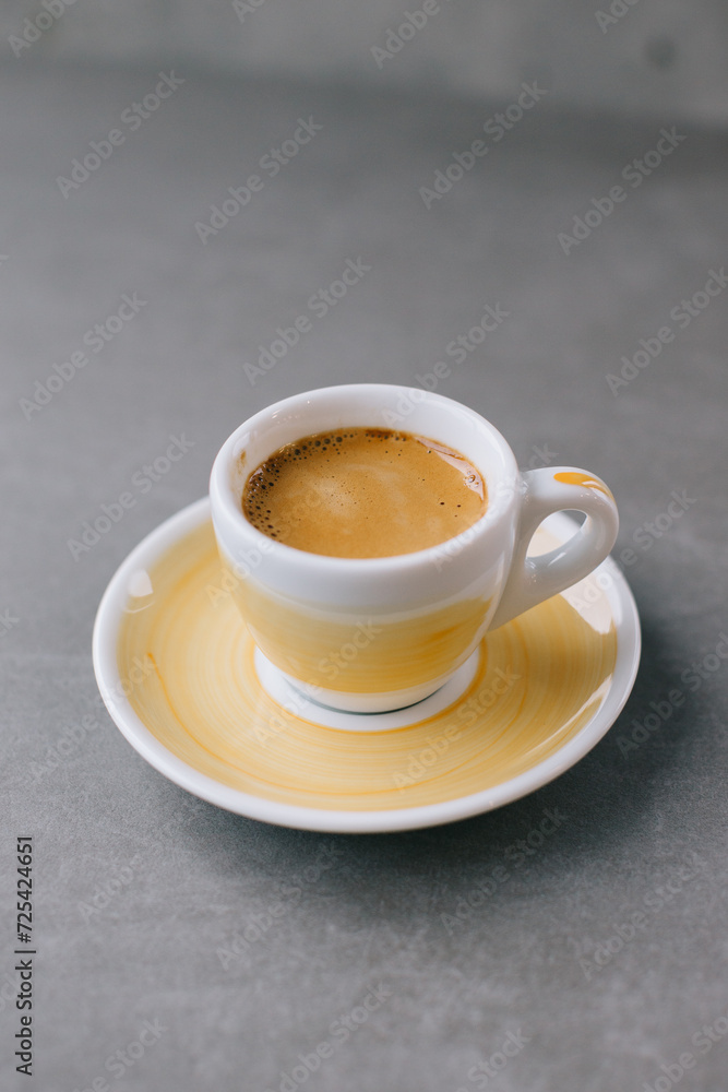 Close up of a cup of espresso or dopio on a gray stone background. Close up of a cup of espresso or dopio on a gray stone background.