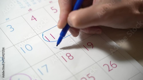 Girl hand of planner writing daily appointment On 2024 Calendar book, working space at home. Asian man plan and noted schedule holiday trip on the diary at office desk. Calendar for planner concept.