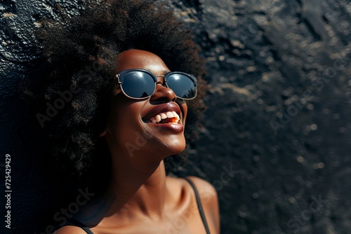 a woman wearing sunglasses and smiling