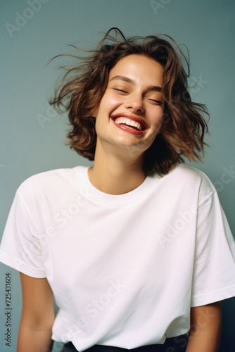 Young happy woman, smiling gen z girl model wearing tshirt looking at camera standing on color background. Face skin care cosmetics makeup, fashion ads. Beauty portrait. White t-shirt mock up template © Synthetica
